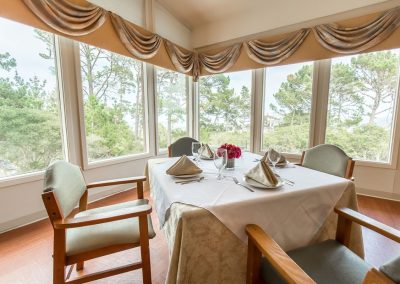 Dining area with linen tablecloths and place settings at Monterey Care Center