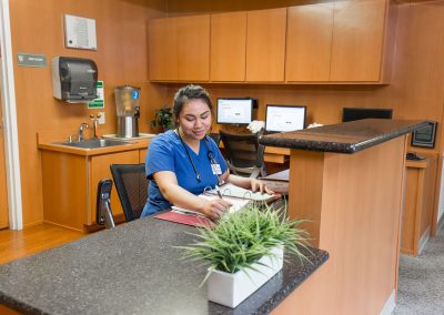 receptionist at the desk and front lobby at Monterey Care Center